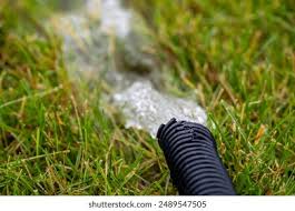 Sump Pump Hose Draining into Grass